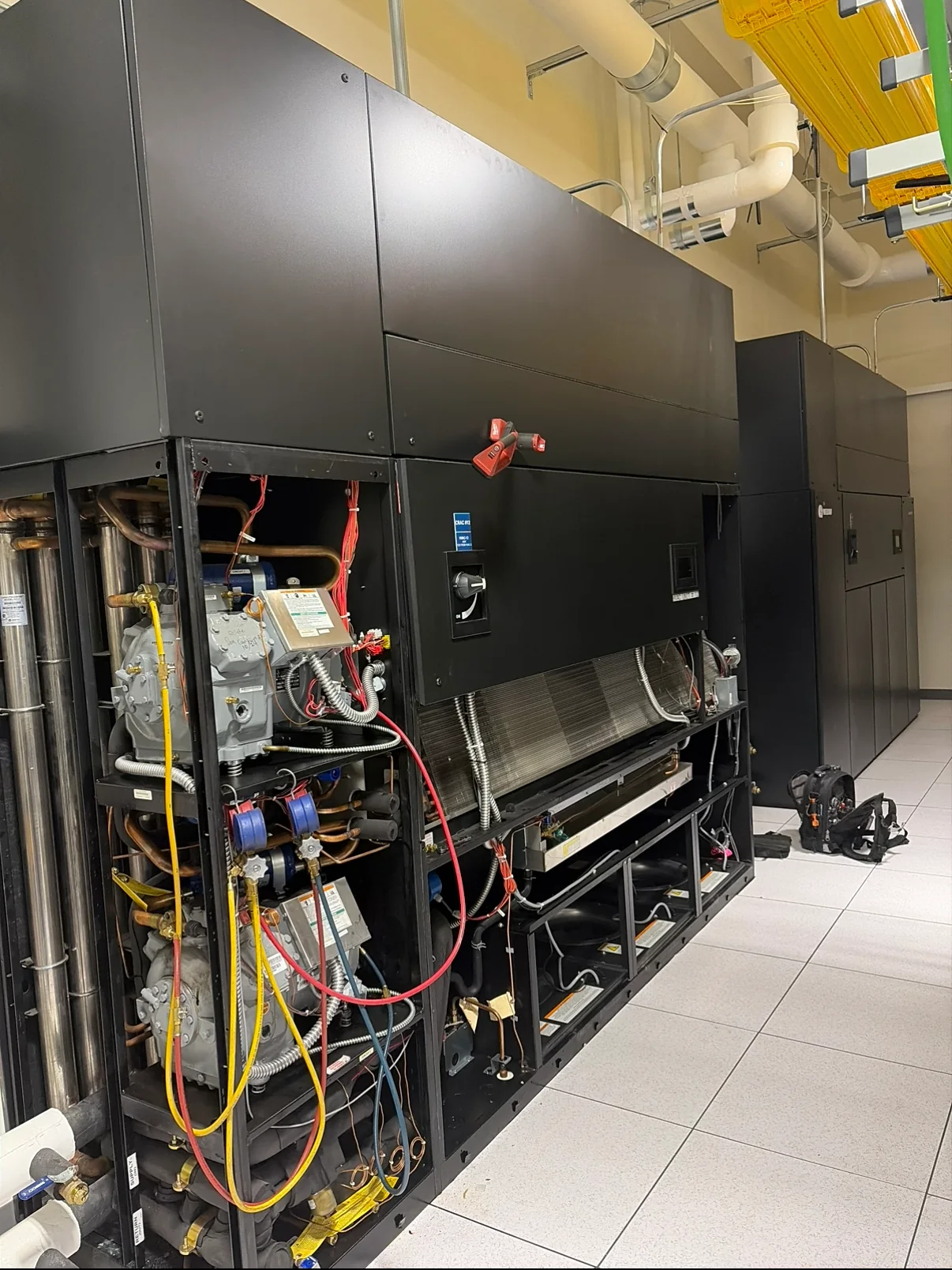 Specialty commercial HVAC equipment opened for diagnostic service in a controlled space